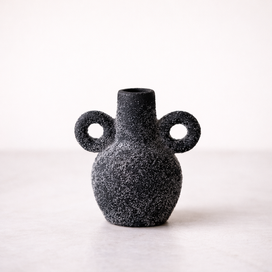 Black speckled terracotta Kos Vase with two circular handles, designed by Luxe B Co, on a white background.