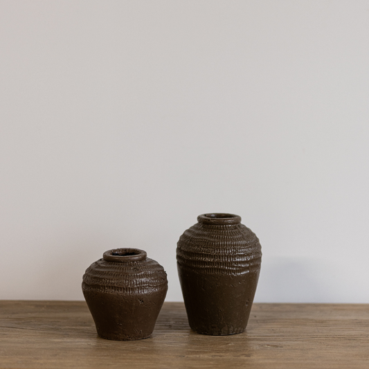 Brown textured ceramic vase by Luxe B Co, featuring a round shape and artistic surface design, perfect for home decor.
