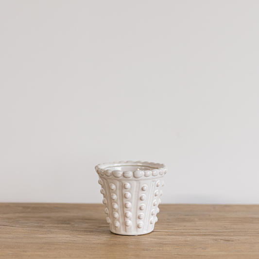 White dotted planter by Luxe B Co with a modern design, featuring a smooth surface and decorative dotted pattern.