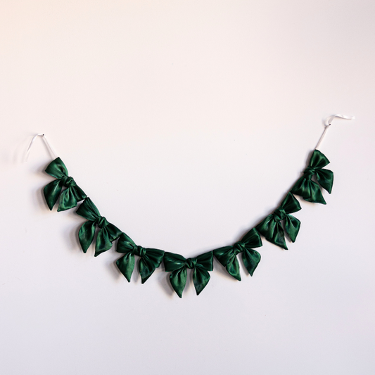 Emerald green gauze bow garland featuring soft, airy fabric bows for decorative event or party decor by Luxe B Co.