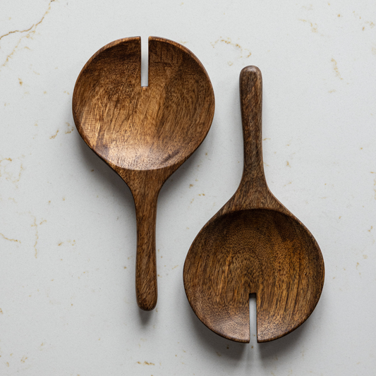 Hand carved mango wood salad servers set by Luxe B Co, featuring natural wood grain and smooth, ergonomic handles.