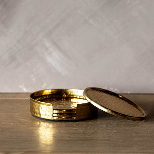 Set of hammered brass and marble coasters by Luxe B Co, showcasing elegant round coasters with textured brass finish and marble surfaces.