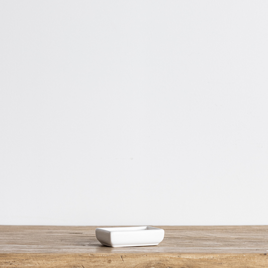 White Luna ceramic soap dish by Luxe B Co, featuring a sleek round design with smooth finish and raised edges for soap storage.