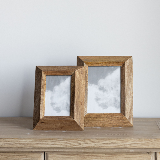 Decorative wood photo frame by Luxe B Co with a natural finish, designed to hold and display cherished photographs.