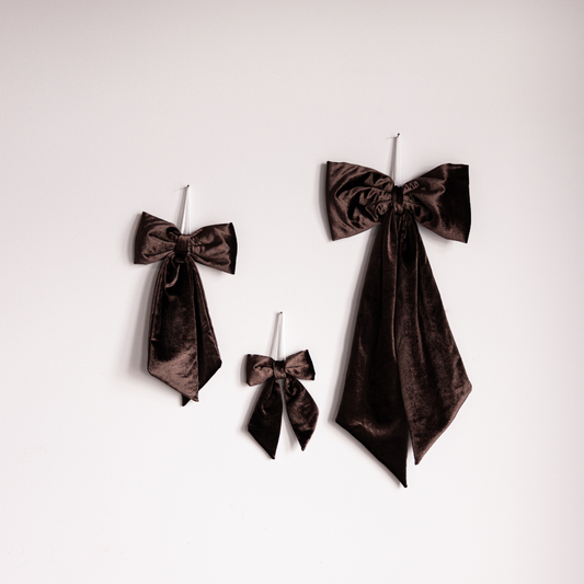Close-up of brown velvet fabric bow from Luxe B Co, showcasing soft velvet texture and elegant design details.