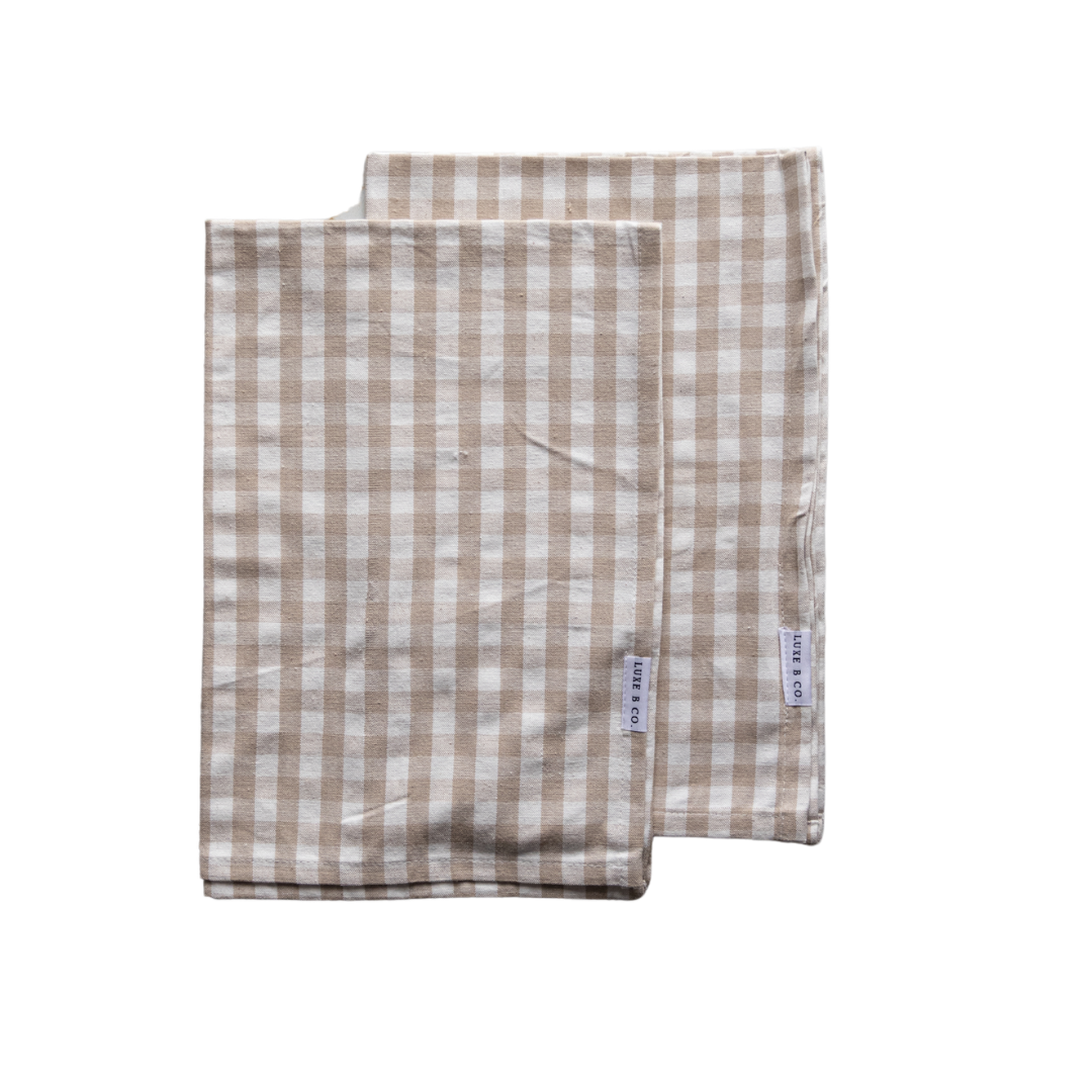 Beige gingham kitchen dish towel by Luxe B Co with checkered pattern, ideal for drying dishes and kitchen decor.
