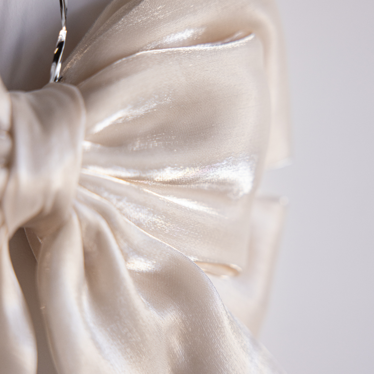 Cream gauze bold bow from Luxe B Co featuring a large, soft fabric bow with a stylish, textured design.