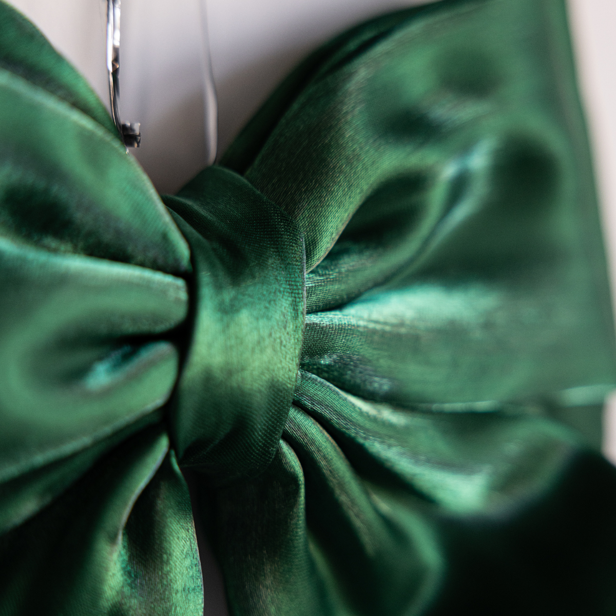 Emerald green gauze bow with bold design, crafted by Luxe B Co, featuring soft, flowing fabric and a prominent bow shape.