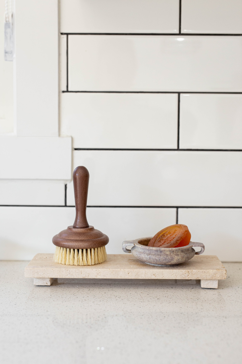 Marble soap dish from Luxe B Co made of soapstone, with a smooth, polished surface and curved edges for holding soap.