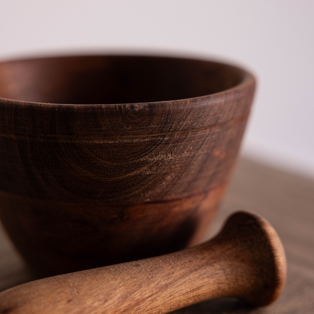 Luxe B Co wooden mortar and pestle for grinding herbs and spices, featuring smooth wood finish and traditional design.