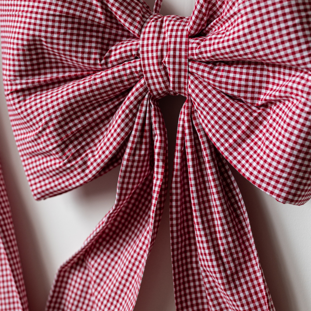 Large red gingham bow from Luxe B Co, oversized fabric bow with a classic checkered pattern, perfect for accessories or decor.