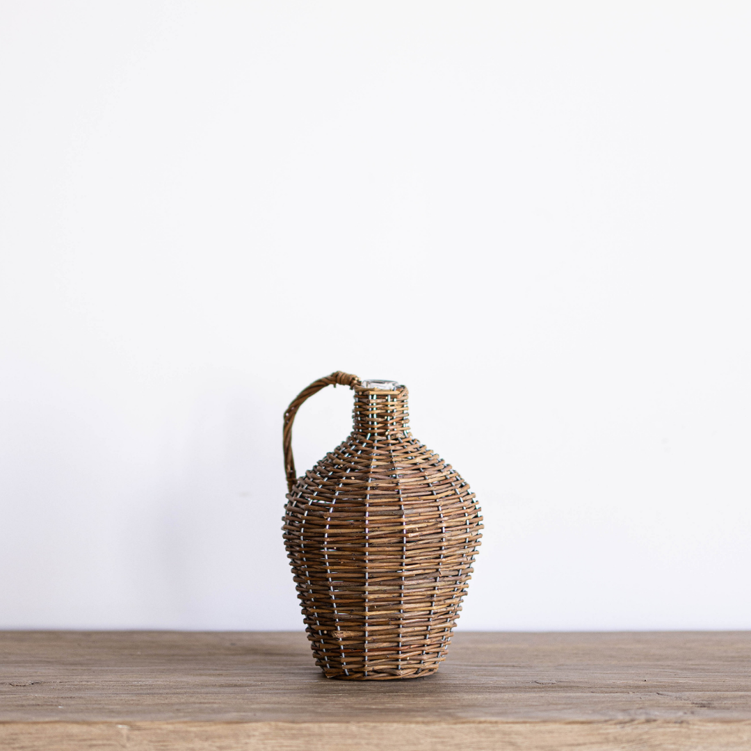 Willow wrapped decorative wine bottle jug by Porch View Home, featuring a rustic, handcrafted design with natural willow accents.