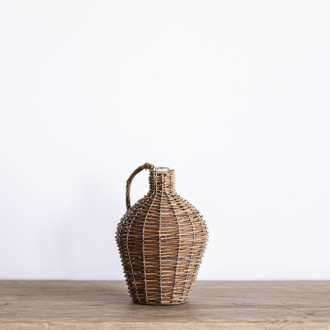 Willow wrapped decorative wine bottle jug by Porch View Home, featuring a rustic design with natural willow accents.