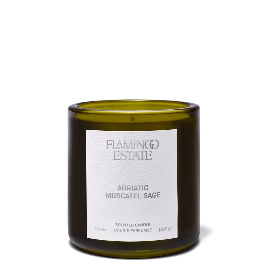 Luxe B Co Adriatic Muscatel Sage Candle with a glass jar and a lit wick, emitting a warm, aromatic glow.
