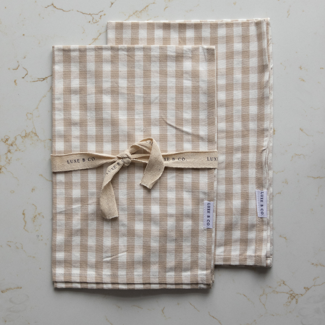 Beige gingham kitchen dish towel by Luxe B Co featuring a classic checkered pattern, perfect for drying dishes and kitchen use.