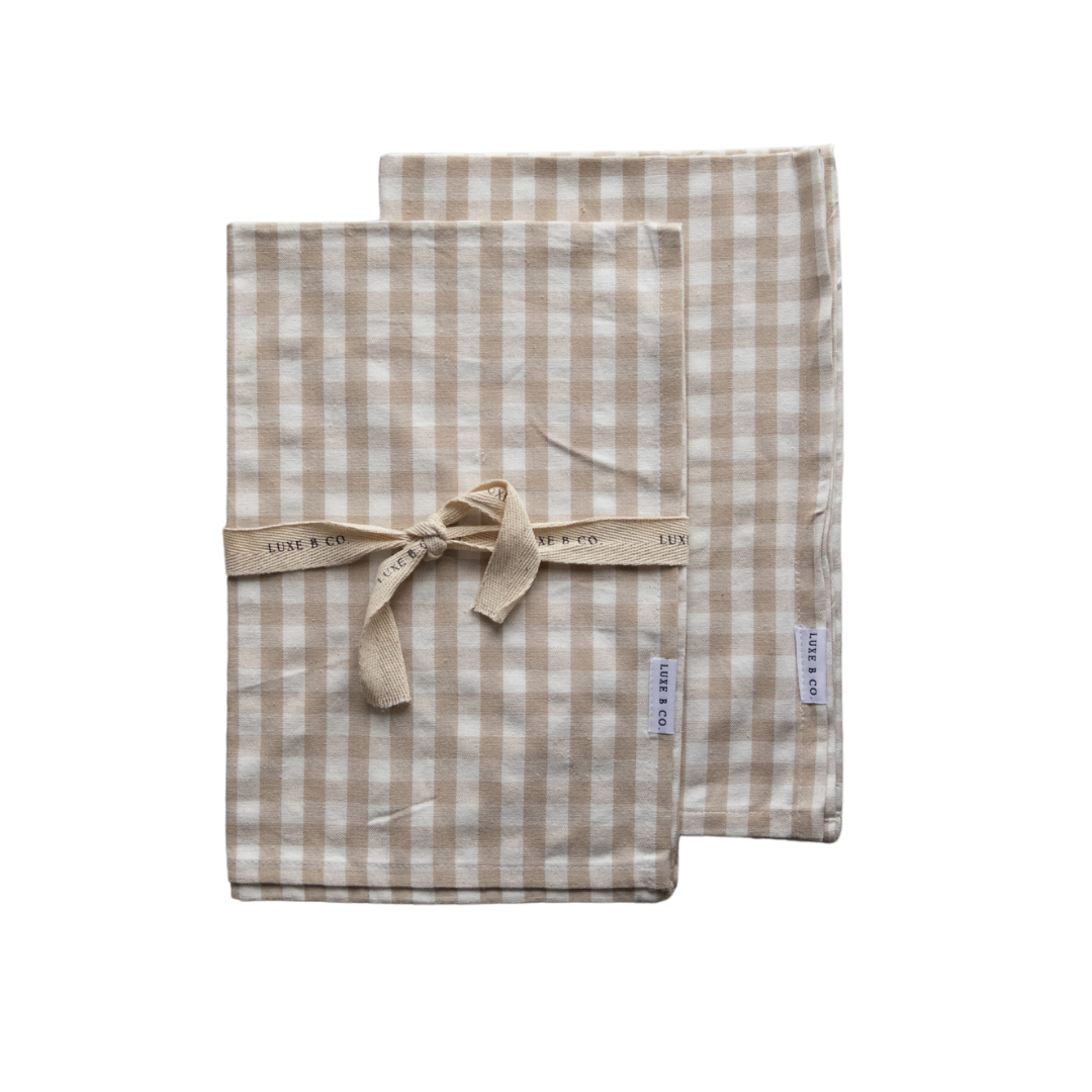 Beige gingham kitchen dish towel by Luxe B Co, featuring classic checkered pattern and soft cotton fabric for drying dishes.