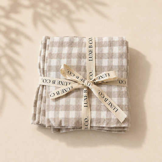 Beige gingham linen dish towels from Luxe B Co, set of elegant, soft fabric napkins for kitchen or dining use.