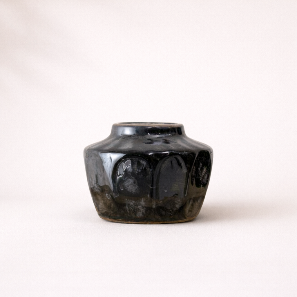 Small black ceramic vase by Luxe B Co, featuring a sleek, modern design perfect for decorative displays.