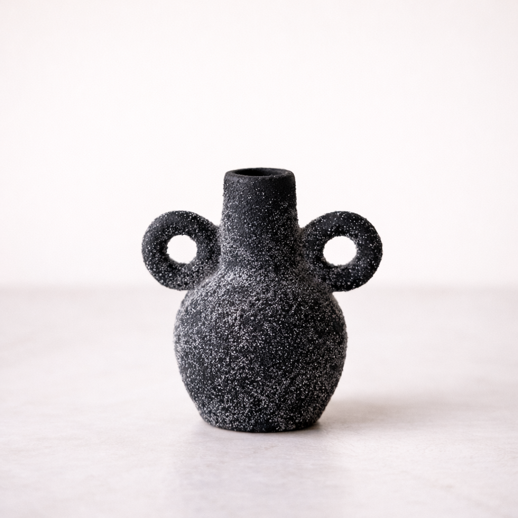 Black speckled terracotta Kos Vase with two circular handles, designed by Luxe B Co, on a white background.