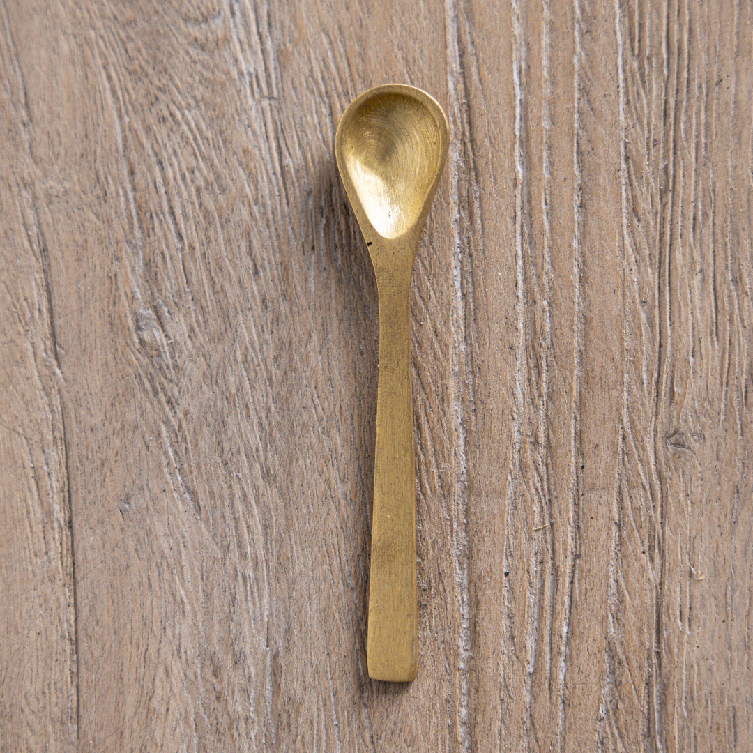 Brushed brass kitchen spoon by Luxe B Co, featuring a sleek handle and polished finish for stirring and serving.