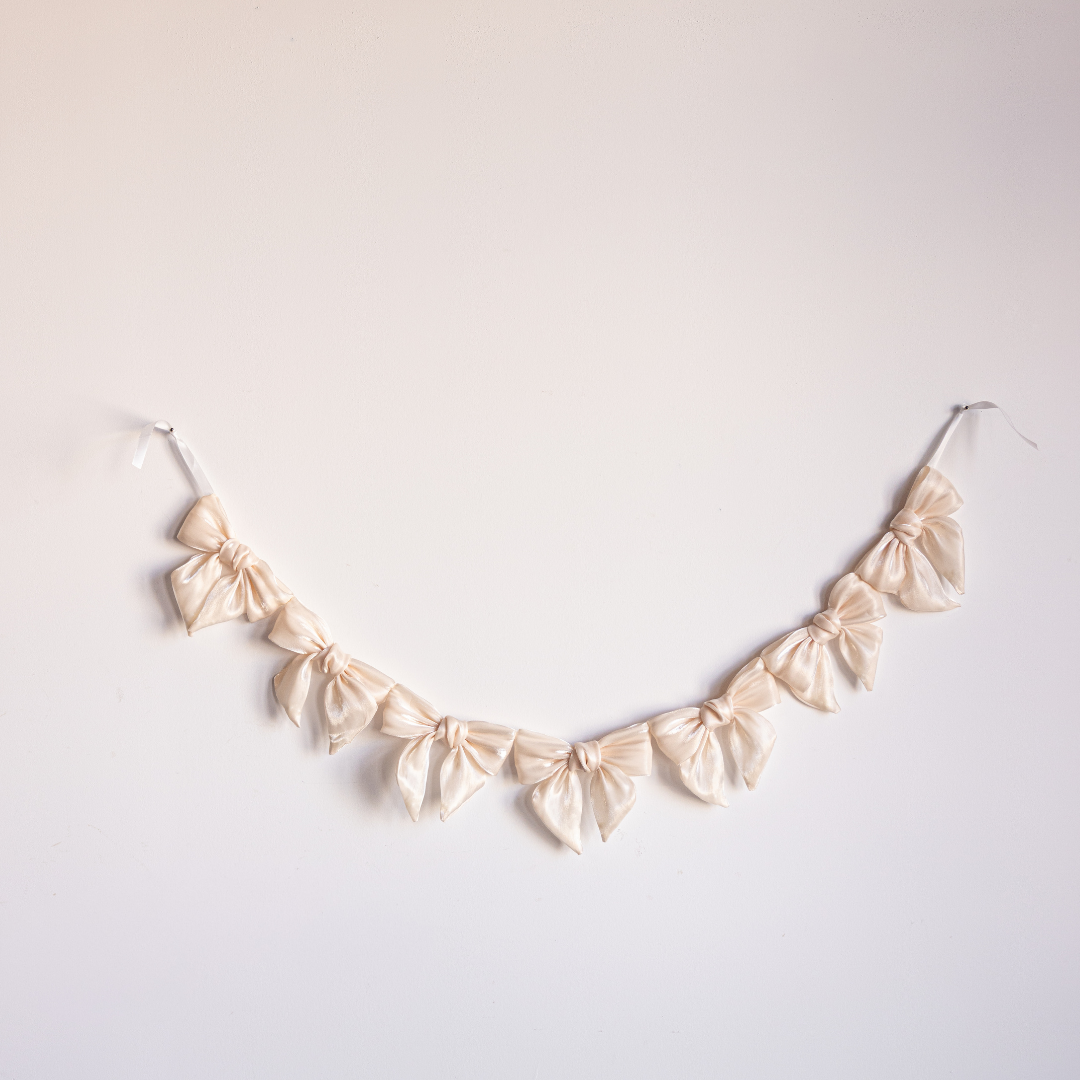 Cream gauze bow garland with soft, flowing fabric bows for decorating, by Luxe B Co.
