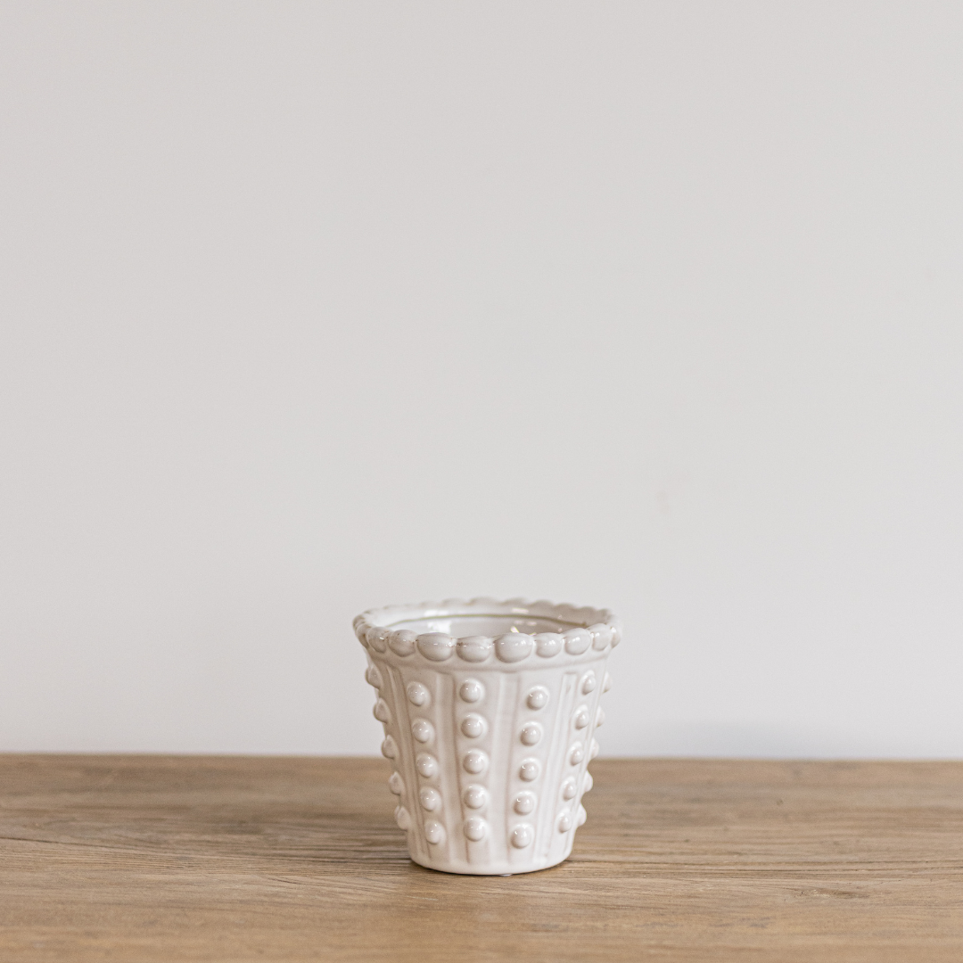 White dotted planter by Luxe B Co with a modern design, featuring a smooth surface and decorative dotted pattern.