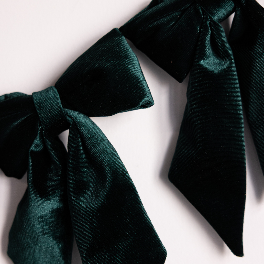 Emerald green velvet fabric bows on a garland, Luxe B Co. decorative bow garland for event or home decor.