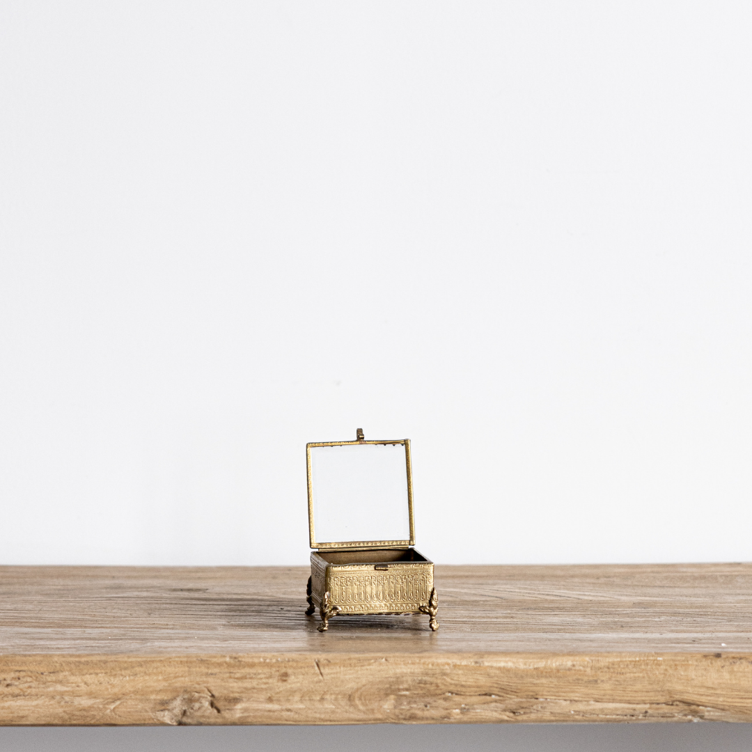 Decorative footed brass and glass box with beveled edges, designed by Luxe B Co for elegant home decor.