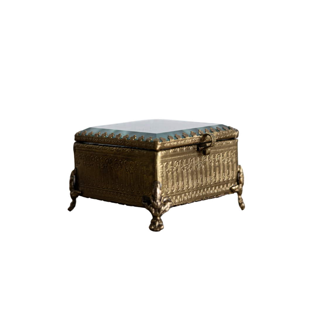 Decorative brass and glass box with footed bevelled design by Luxe B Co, showcasing elegant craftsmanship and transparent glass panels.