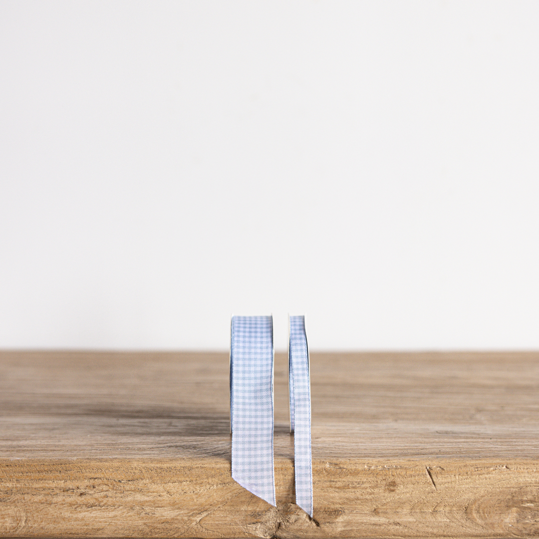 Sky blue gingham ribbon by Luxe B Co, featuring a classic checkered pattern, perfect for gift wrapping and craft projects.