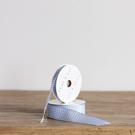 Sky blue gingham ribbon by Luxe B Co, featuring a classic checkered pattern, perfect for crafts and gift wrapping.