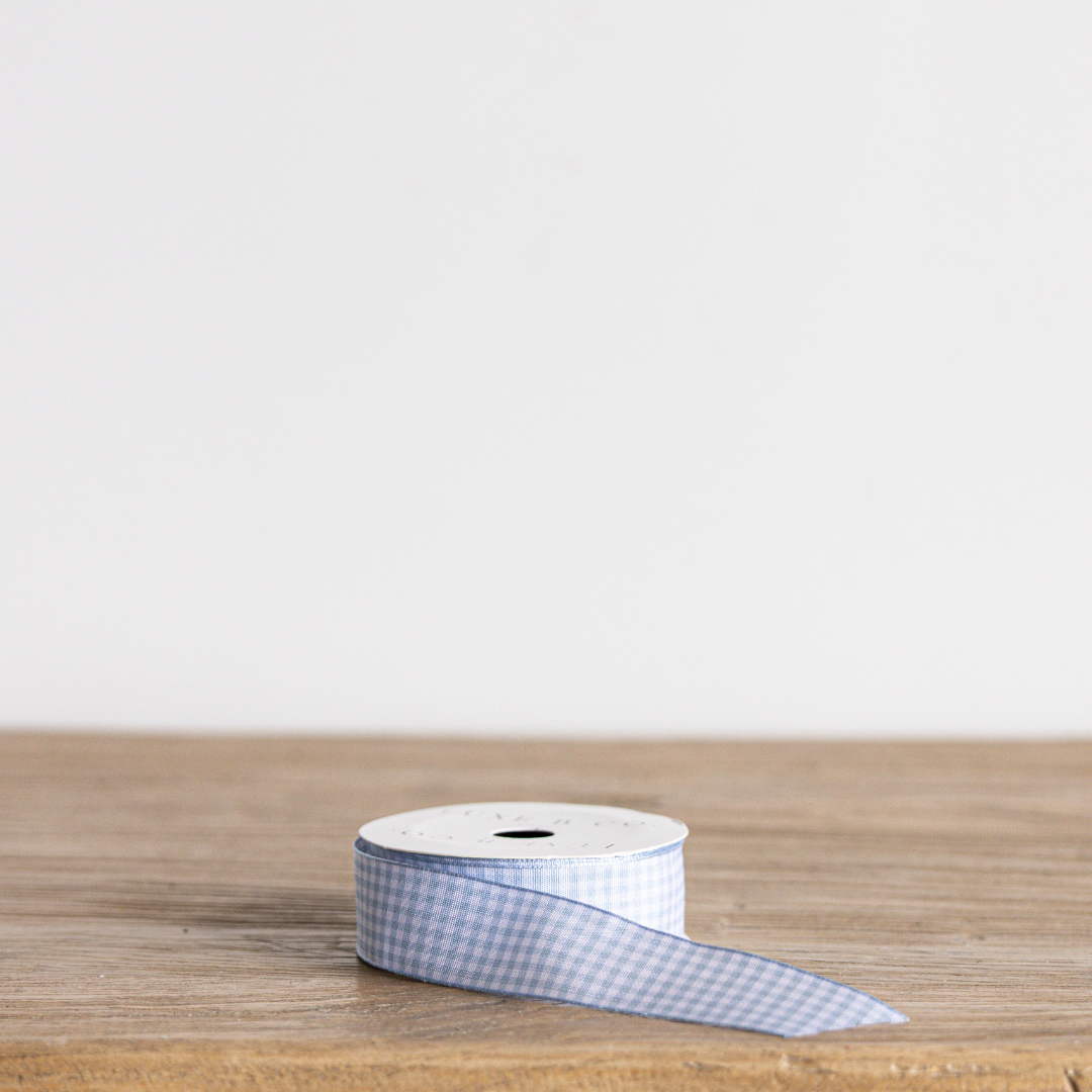 Sky blue gingham ribbon by Luxe B Co, featuring a classic checkered pattern, ideal for gift wrapping or crafting.