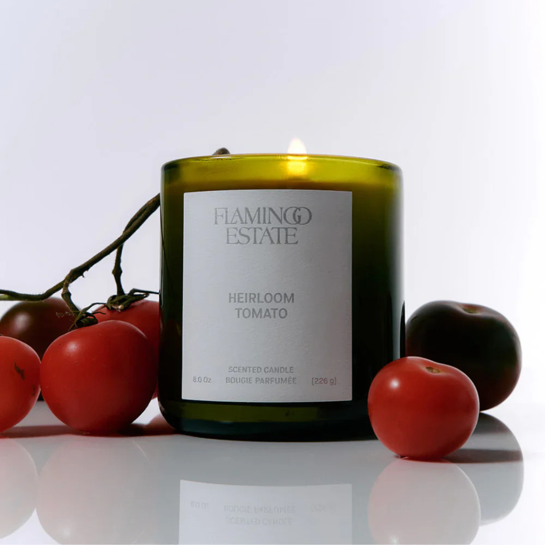 Heirloom tomato-shaped candle by Luxe B Co with realistic red and green details, perfect for decorative lighting.