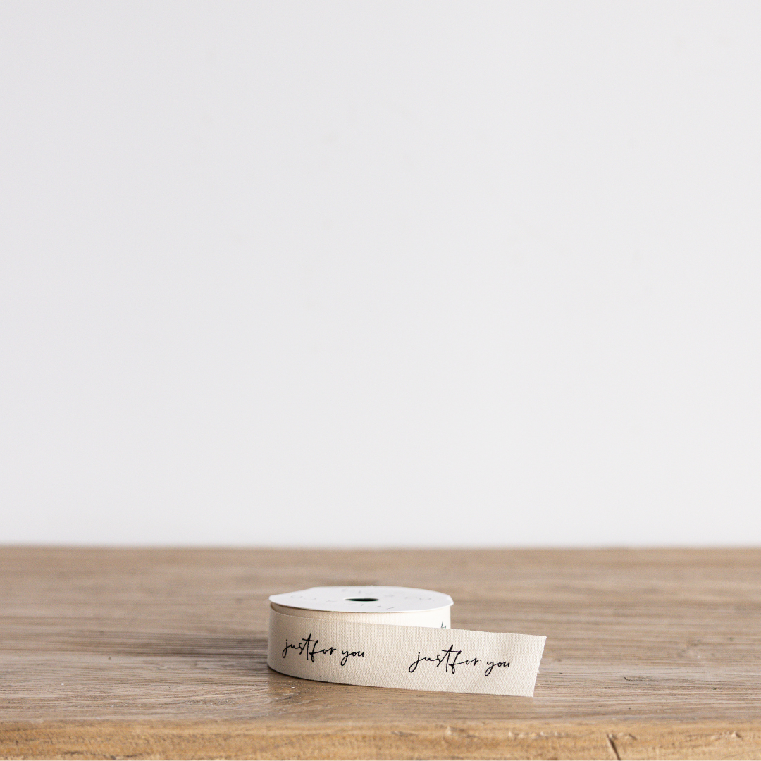 Cursive writing ribbon with "Just For You" message by Luxe B Co Wholesale, decorative fabric ribbon for gift wrapping and crafts.