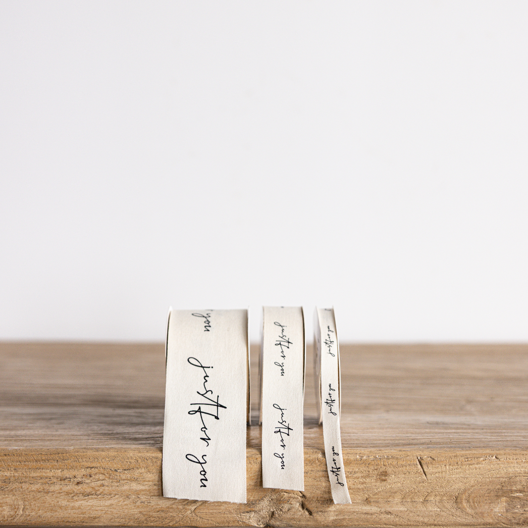Cream-colored ribbon with cursive "Just For You" writing, designed by Luxe B Co Wholesale, perfect for gift wrapping and crafts.