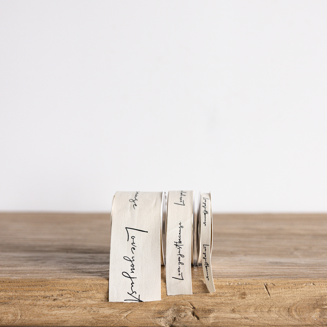 Cursive writing ribbon with "Love You Just Because" by Luxe B Co Wholesale, featuring elegant, decorative ribbon design.