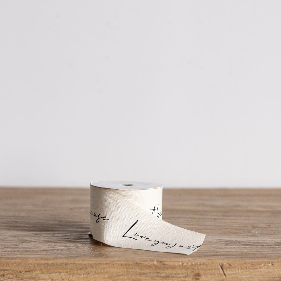 Cursive "Love You Just Because" ribbon by Luxe B Co Wholesale, featuring elegant script on a satin ribbon background.