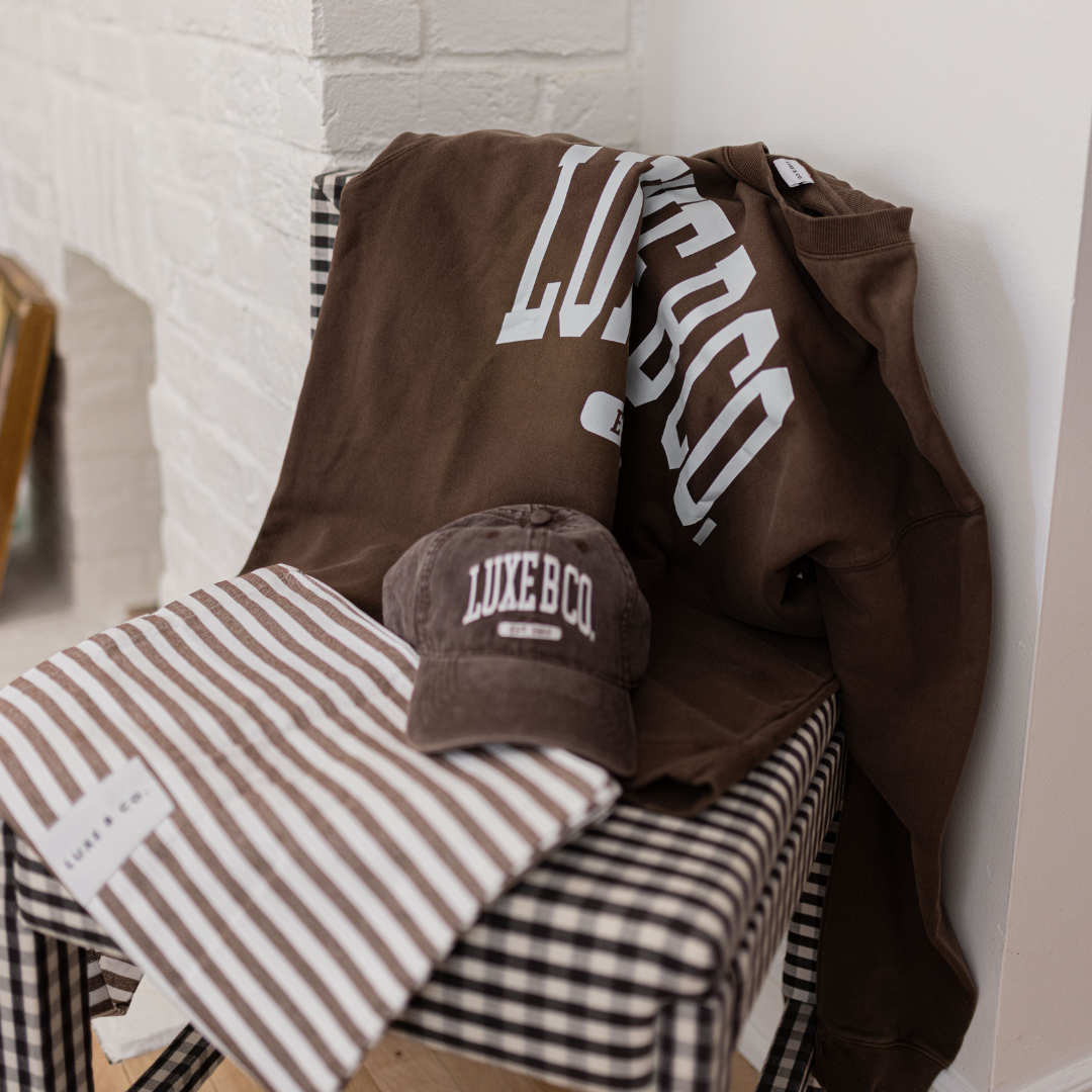 Luxe B Co. brown baseball cap with curved brim and adjustable strap, stylish casual hat for everyday wear.