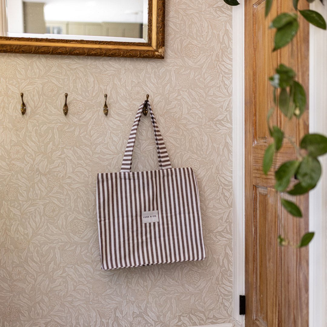Brown striped tote bag by Luxe B Co with sturdy handles and spacious interior, perfect for daily use and stylish accessories.