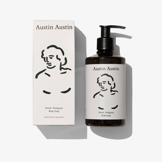 Austin Austin Neroli and Petitgrain body wash in a clear bottle, showcasing the luxurious soap with fresh citrus fragrance.
