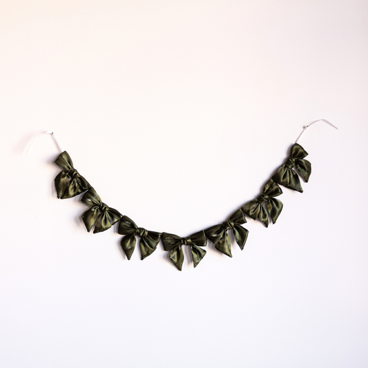 Olive green gauze bow garland by Luxe B Co, featuring soft, airy fabric bows ideal for decorations and festive events.
