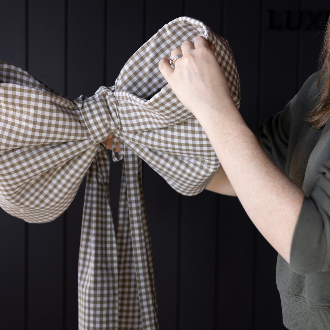 Large green gingham fabric bow by Luxe B Co, showcasing an oversized stylish accessory with a classic checkered pattern.