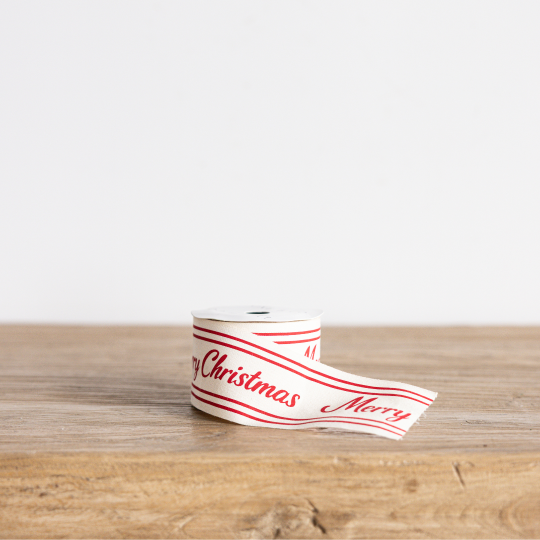 Red cursive Merry Christmas ribbon by Luxe B Co Wholesale, featuring festive holiday greeting in elegant red script.