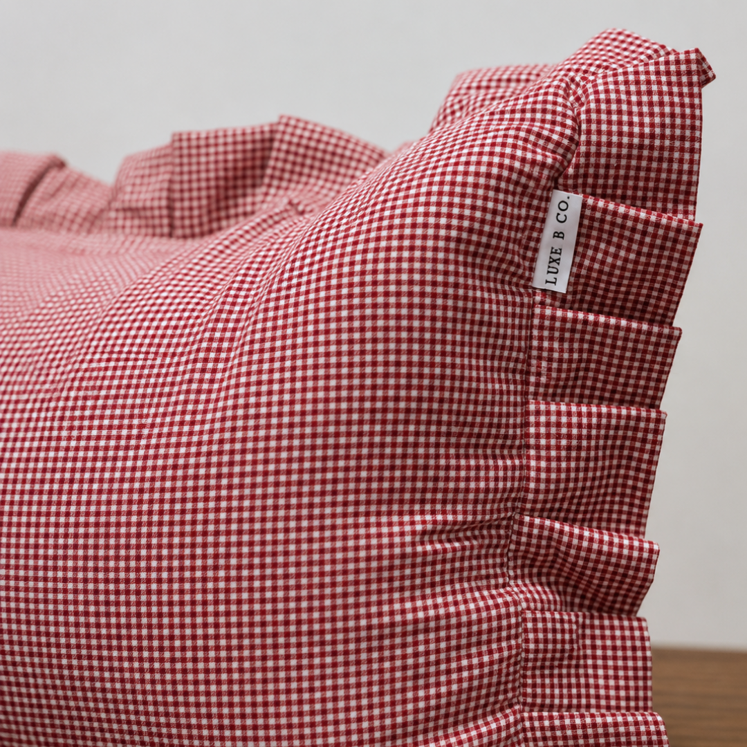 Red mini gingham ruffle bolster pillow cover by Luxe B Co, featuring a charming ruffled design for decorative cushions.