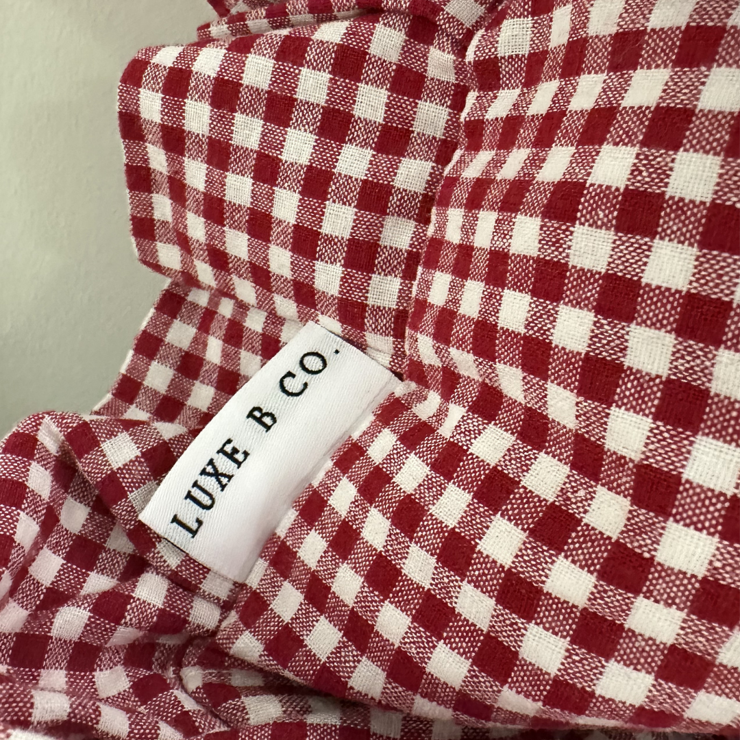 Red gingham lumbar pillow sham with ruffle detail from Luxe B Co, showcasing a charming, small-scale pattern ideal for cozy decor.