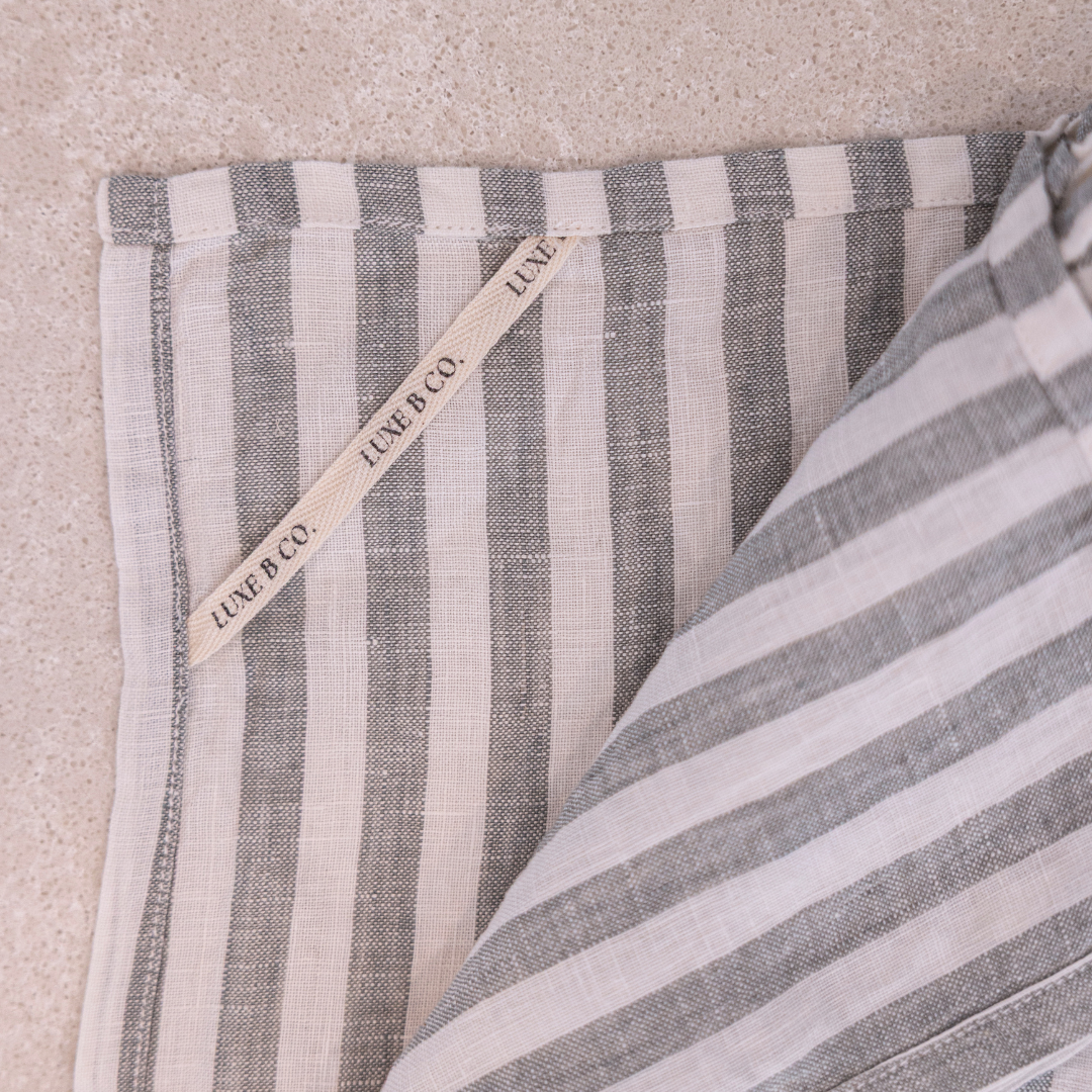 Soft green linen dish towel with ruffles from Luxe B Co, showcasing a delicate, textured fabric ideal for kitchen use.