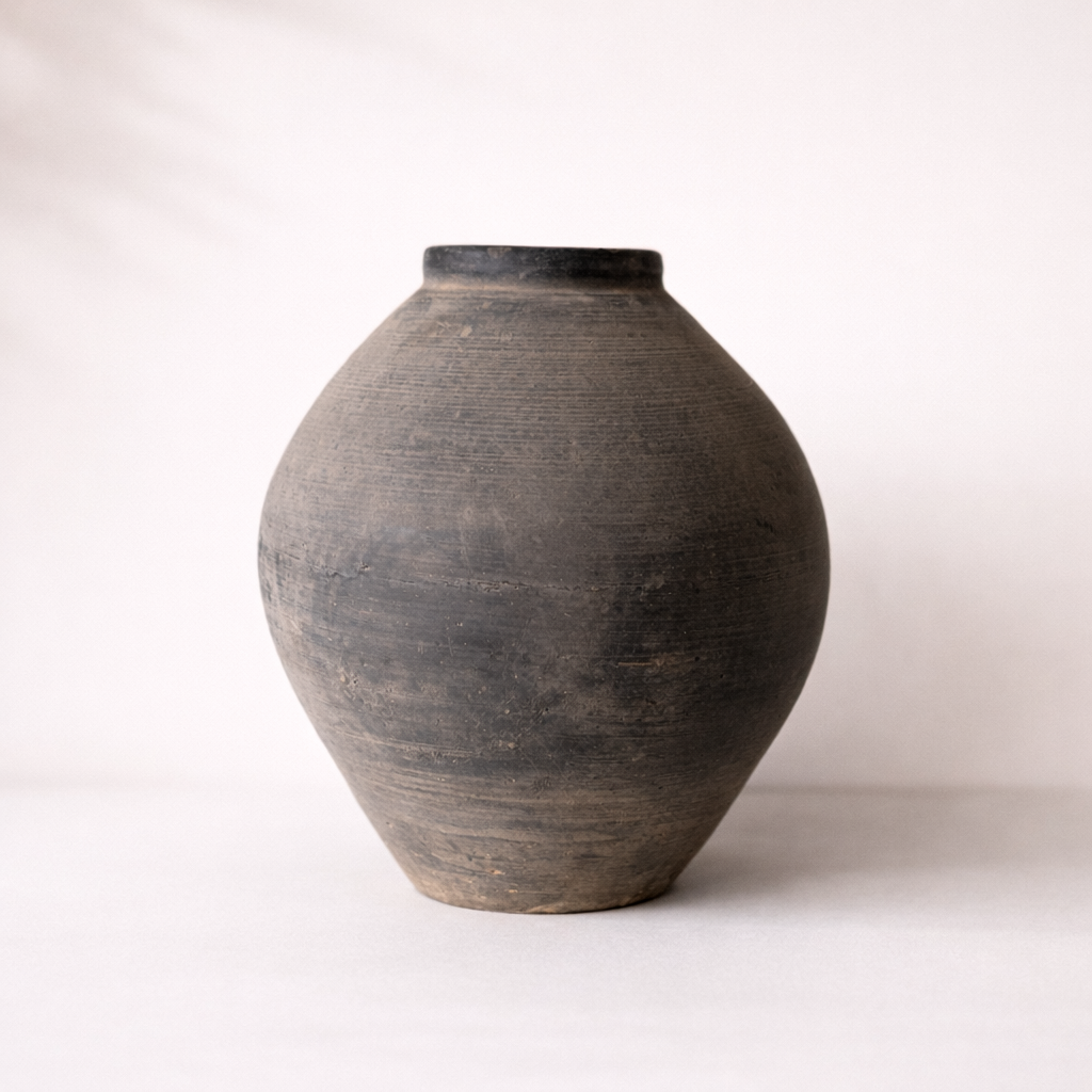 Black ceramic vase on a white background