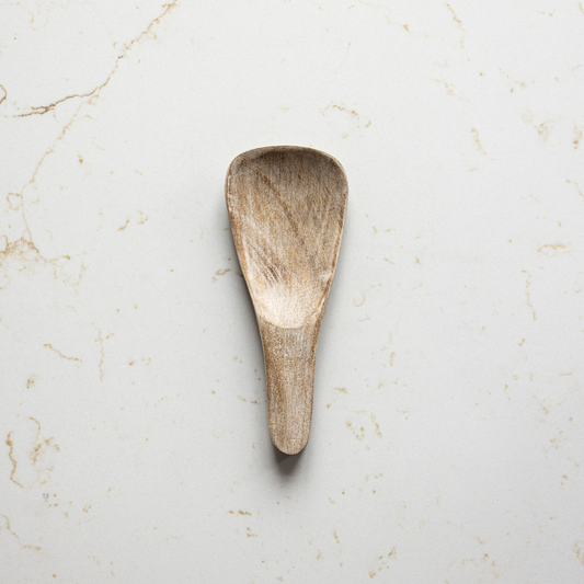 Washed wood spoon rest by Luxe B Co, round wooden kitchen accessory with a smooth, natural finish for resting cooking spoons.