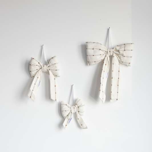 White and light green dotted striped bows by Luxe B Co, featuring a playful design with contrasting patterns and soft fabric textures.