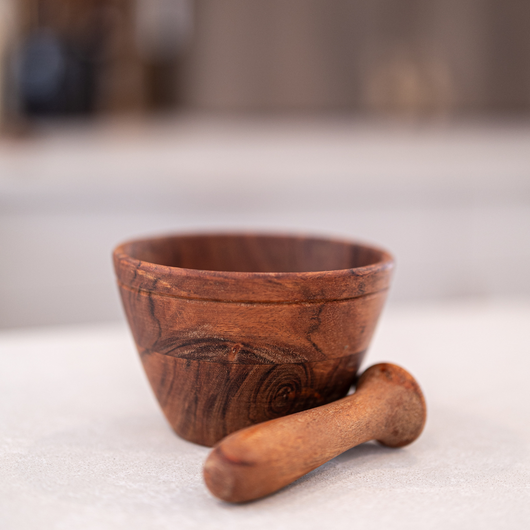 Wooden mortar and pestle by Luxe B Co, showing a smooth, round wooden bowl with pestle for grinding spices and herbs.
